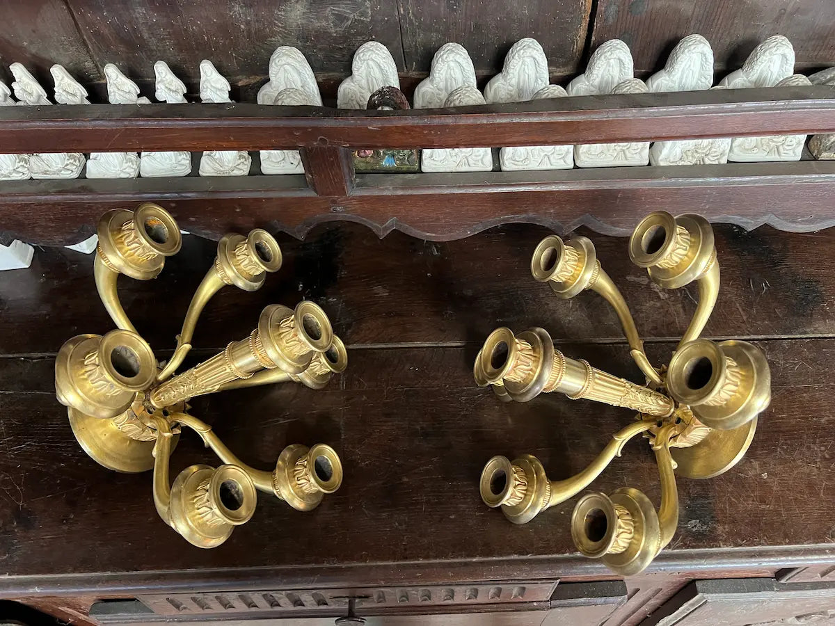 Pair of antique gilded bronze wall candelabra with seven candle holders, plus a matching damaged piece, perfect for restoration or liturgical décor.
/ Paire d’appliques murales anciennes en bronze doré avec sept bougeoirs, accompagnée d’une pièce assortie endommagée, idéale pour restauration ou décoration liturgique.
