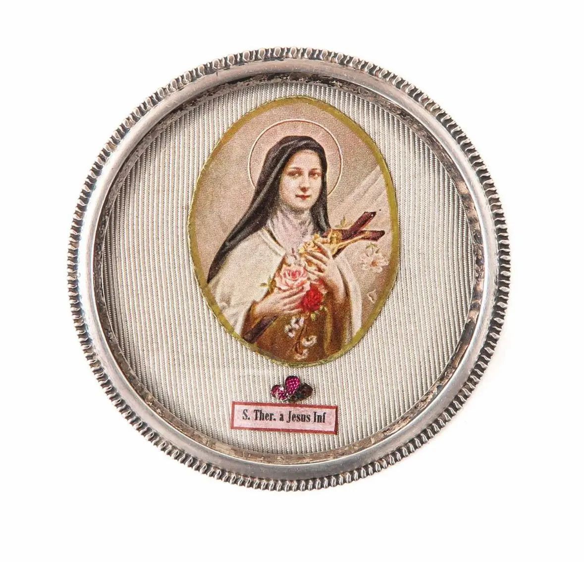 Sacred relic of St. Thérèse of the Child Jesus in a 6 cm circular reliquary.
/
Relique de Sainte Thérèse de l’Enfant Jésus dans un reliquaire circulaire de 6 cm.